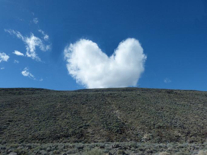 Heart shaped cloud on mountain